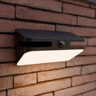 LUTEC AERO LED solar-powered outdoor wall lamp, black, 21 cm, sensor, IP54